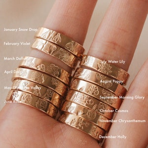 Thick gold-tone birth flower month ring with engraved floral design and month names