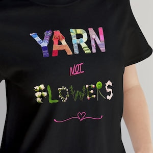 Black graphic T-shirt with “YARN” and “LOVERS” text and heart details