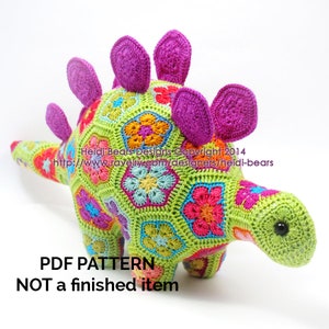 Crochet stegosaurus pattern, lime green body with pink spikes and colorful flower motifs