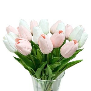 Artificial tulip flower stems with pastel pink and white blooms, green leaves.