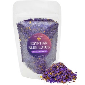 Pre-ground organic blue lotus petals and stems in resealable white pouch, with loose petals.