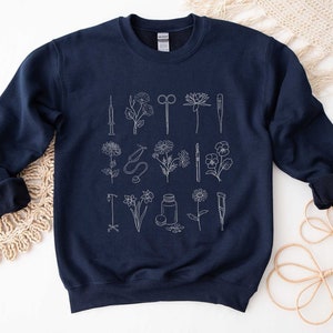 Navy medical sweatshirt with minimalist stethoscope and medical icon graphic, crewneck