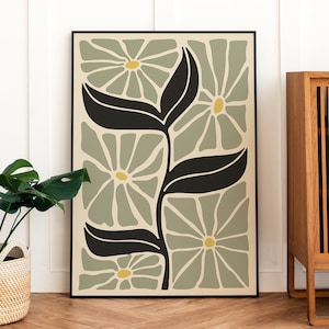 Sage green botanical wall art print with layered flower and leaf illustration in black frame