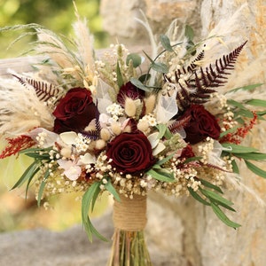 Burgundy and cream dried wedding bouquet with roses, pampas grass, and greenery