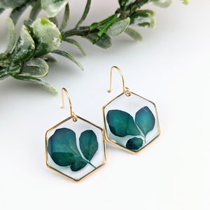 Hexagon resin flower drop earrings with pressed blue-green petals, gold-tone hooks