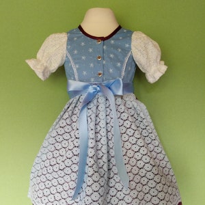 Baby dirndl dress with blue bodice, puff sleeves, patterned skirt, lace apron