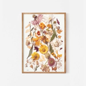 Framed botanical wall art with dried wildflower print in yellow, pink, and brown