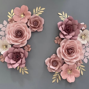 Mauve pink paper flower wall decor set with layered blooms, gold leaves, and small daisy accents