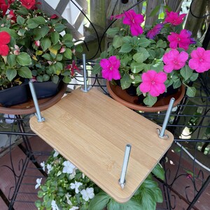 Wooden flower press with metal brackets and butterfly-style tightening knobs