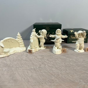 Department 56 Snowbabies ceramic figurines, several white snow-themed baby characters