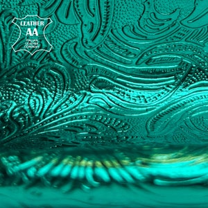 Shiny emerald green metallic lambskin with raised flower print pattern close-up