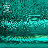Shiny emerald green metallic lambskin with raised flower print pattern close-up