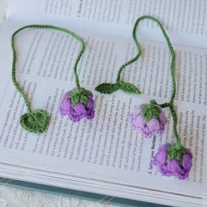 Crochet lily of the valley bookmark with green-and-purple flower clusters and hanging loops