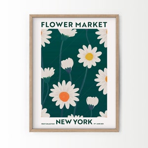 Framed floral wall art print with daisies and “NEW YORK” text