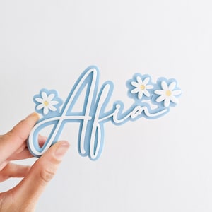 Blue script-name floral acrylic cake charm with double-layer flowers