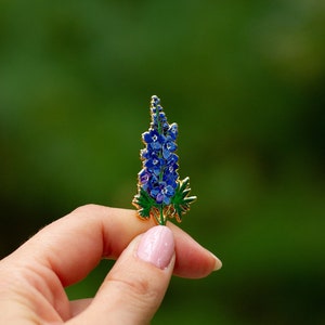 Blue floral enamel lapel pin with clustered delphinium design