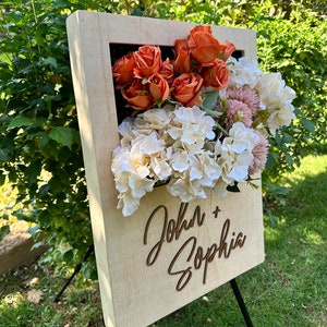 Wedding welcome sign in wooden box with floral roses and cursive text John + Sophia