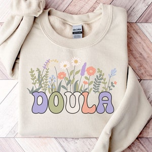 Cream crewneck sweatshirt with colorful wildflower graphic and DOULA text