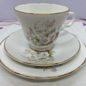 Fine bone china tea cup and saucer with pink floral print and gold rim