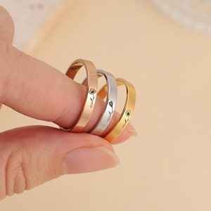 Thin delicate stacking rings in rose gold and silver with small floral details