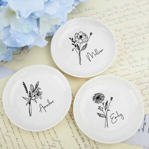 Round white ceramic ring dishes with black daisy-style flower line art, set of three