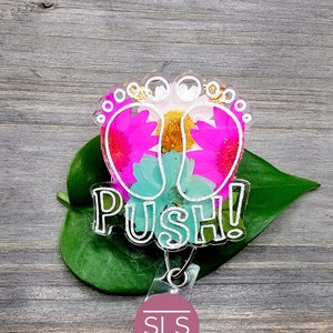 Floral badge reel with green leaf base, pink heart shoes, and "PUSH!" text