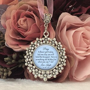 Round personalized wedding bouquet charm with blue script, silver floral frame and dangling loop