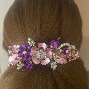 Gold hair clip with pink and purple flower design and rhinestone accents