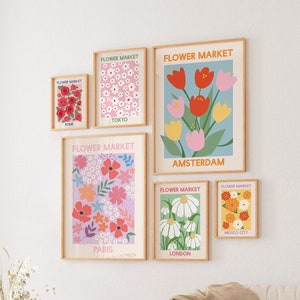 Framed botanical gallery wall with five pastel flower and city-themed prints