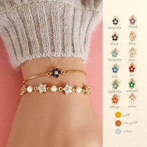 Gold freshwater pearl bracelet with blue flower charm and daisy-shaped accents
