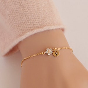 Gold flower girl bracelet with small flower charm and heart pendant