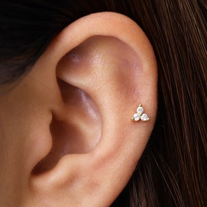 Tiny lotus flower flatback labret stud earring on ear cartilage, white crystal petals