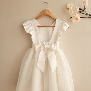 White tulle flower girl dress with cap sleeves and waist bow