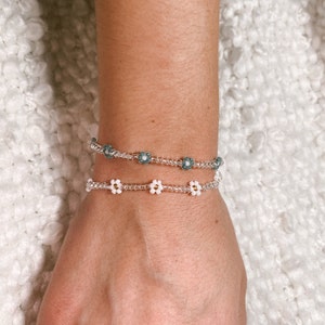 Silver beaded flower bracelet with spaced blue and white beads