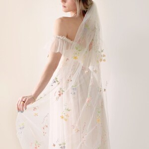 Sheer white bridal veil with delicate botanical floral embroidery and ribbon trim