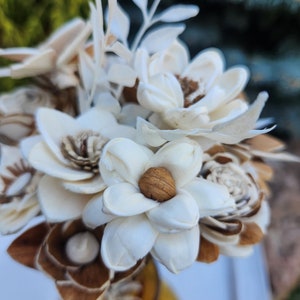 Mini bouquet of white and tan wooden flowers with a central brown bloom