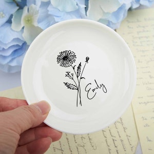 White ceramic ring dish with black flower stem and cursive personalization