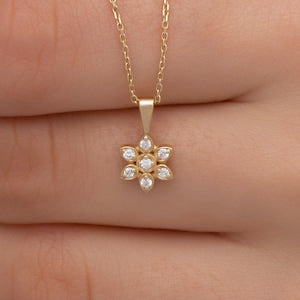 Gold diamond flower pendant necklace with small four-petal stone detail