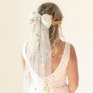 White floral embroidered tulle veil with bow headpiece, sheer ribbon drape