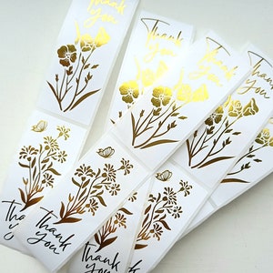 Metallic gold thank you flower stickers with botanical line art, multiple designs