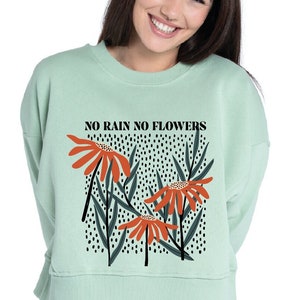 Mint crewneck sweatshirt with 'NO RAIN NO FLOWERS' and orange wildflower graphic