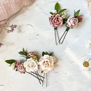 Floral hair pins set with blush and white roses, green leaves, and three pin stems