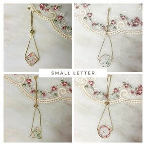 Gold adjustable monogram bracelet with small letter charm and floral dried flower pendant