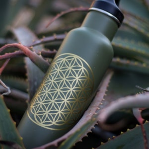 Sacred geometry Flower of Life decal sticker, gold outline on dark green bottle