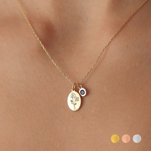 Sterling silver birth flower charm necklace with blue birthstone pendant on a chain