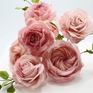 Wafer paper rose cake topper with five pink edible roses and green leaves