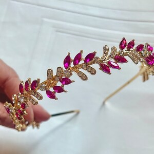 Gold-tone headband with bright pink marquise rhinestones and curved jeweled band