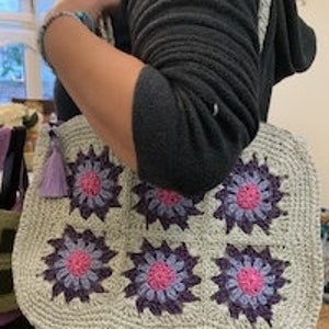 Handmade woven handbag with purple and pink flower appliques