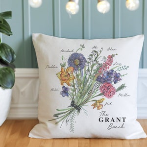 Personalised family birth month flower cushion, cream with colorful floral leaves design