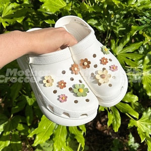 Multicolour resin flower shoe charms on a white slip-on shoe